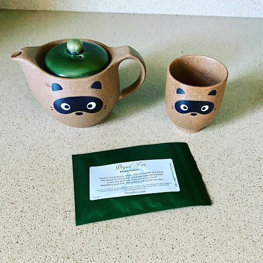 tea pot, mug and package of tea