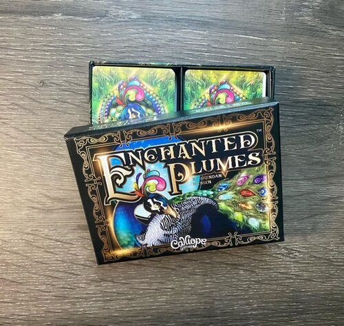 Enchanted Plumes Box, featuring a large peacock 