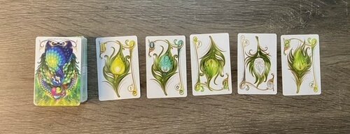 Run of cards featuring peacock feathers 