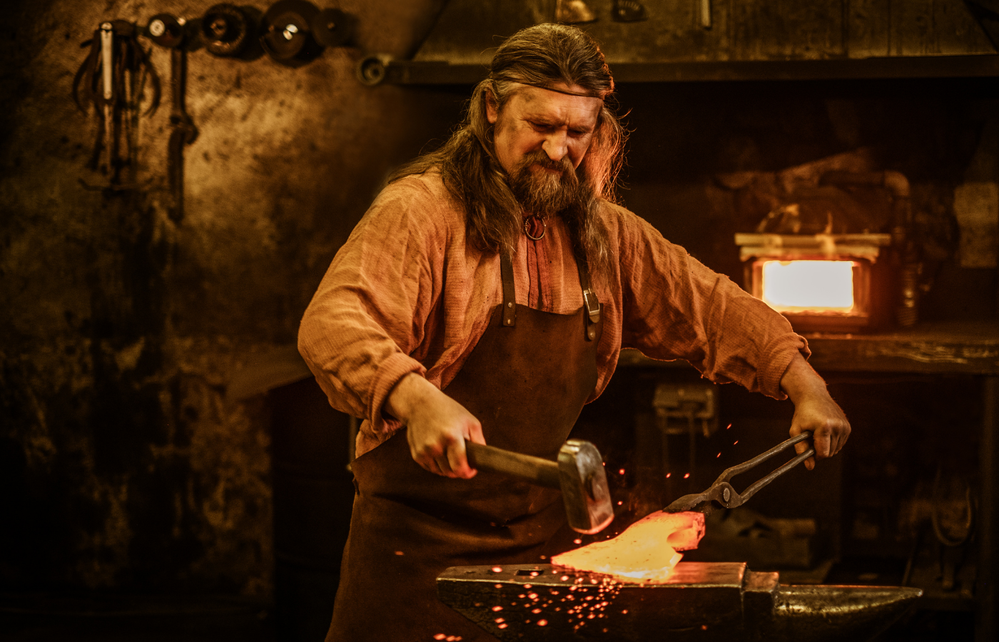 Blacksmith working on forging an ax
