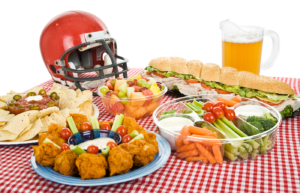 A football helmet on a table with platters of food