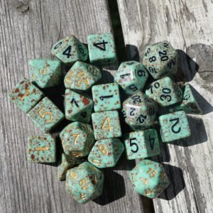 Mint colored polyhedral dice with brown spots