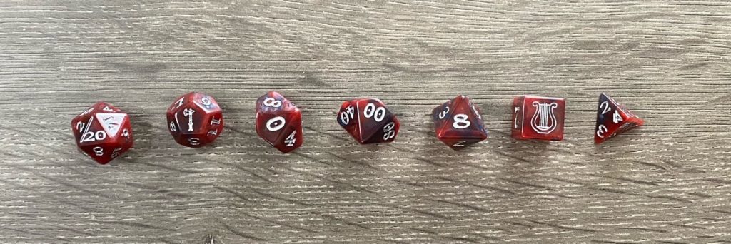 a set of polyhedral dice laid out from largest to smallest