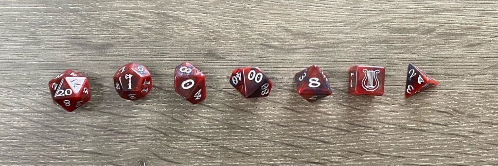 a set of polyhedral dice laid out from largest to smallest