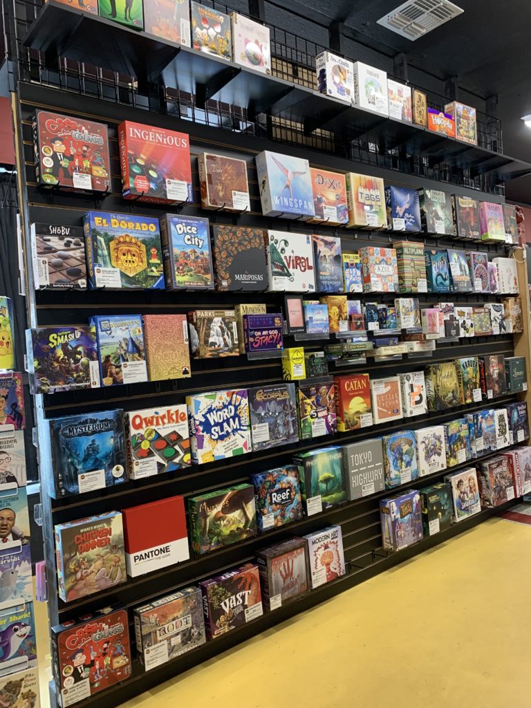 An array of board games for purchase at BAMF Comics. Several Board games are also available to rent for the day.