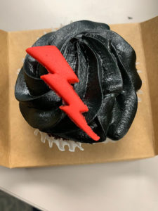 Cupcake with black frosting and red lightning bolt