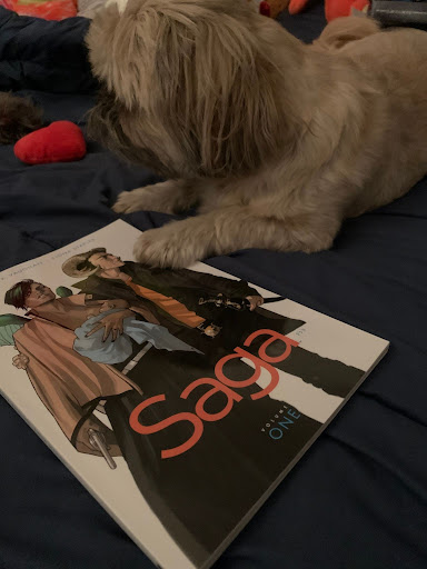 Puppy sitting by a saga comic